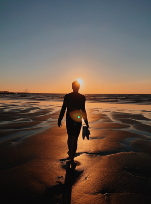 man walking in sunset