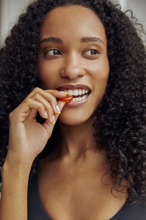 Girl eating Cannaray CBD Orange Flavoured Gummy