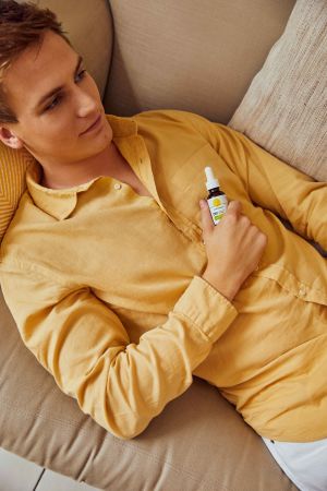 Man lying down with Cannaray CBD Oil 