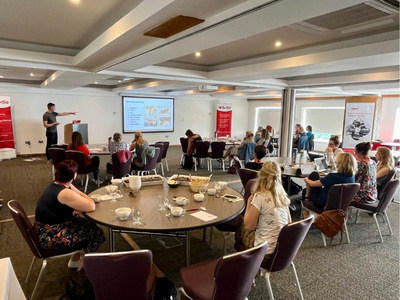 Delegates sat around tables watching a HeartVets lecture