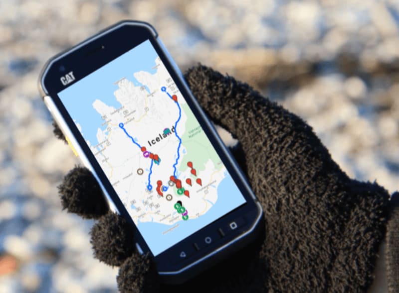 Image of a person holding a phone with Google Maps on the screen of Iceland - Iceland Car Rental