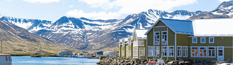 Image of boats sitting near a dock in Siglufjordur, Iceland.