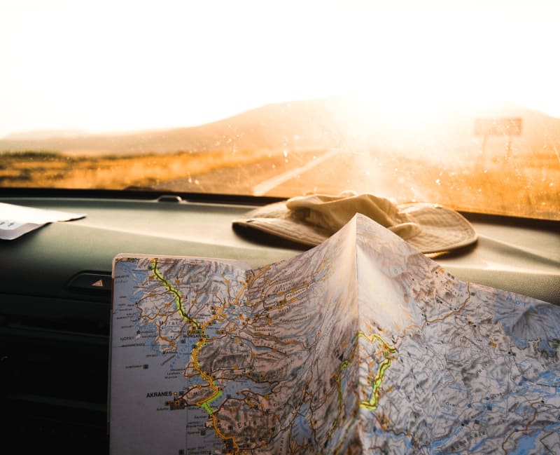 Image of a map of Iceland while driving in the winter sun in Iceland