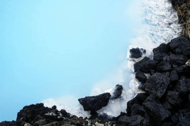 Image of the blue lagoon\'s blue water and beautiful natural lava rocks
