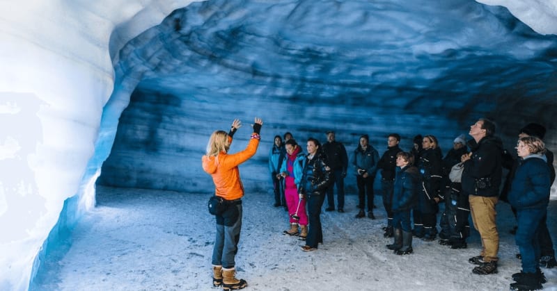 Image of people standing inside Langjokull Glacier on a tour with a guide.