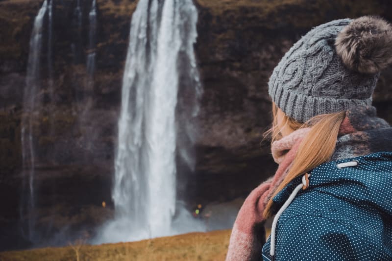 Image of a person looking at waterfall in Iceland