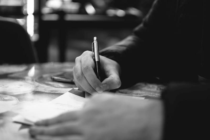 Image of a person signing a car rental agreement