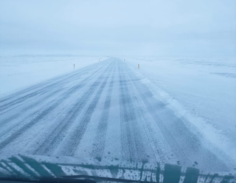 Image of a snowy and windy condition while driving in Iceland.