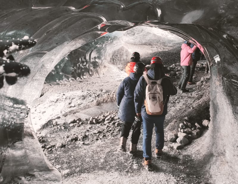 Image of travelers in Iceland exploring caves