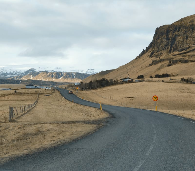 Image of a road in Iceland, clear skies and beautiful scenery.