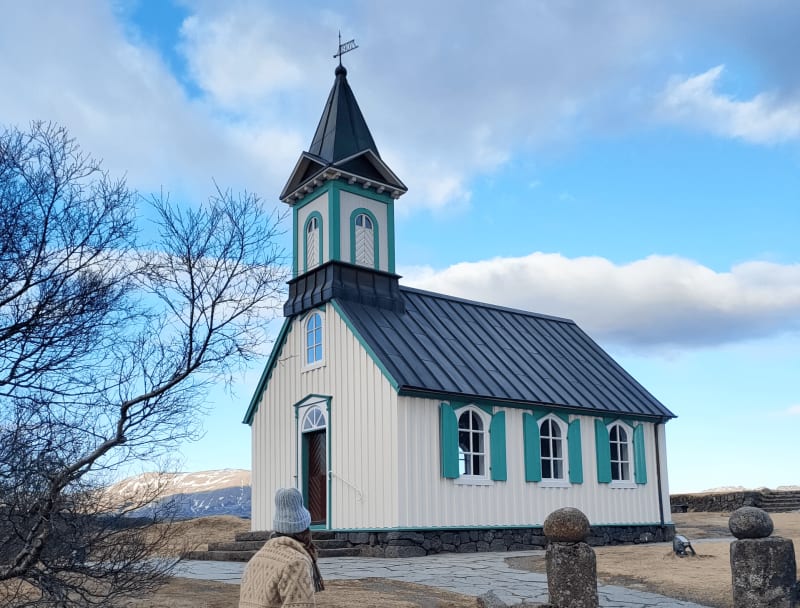 Image of a person walking towards Thingvallar kirkja in Iceland