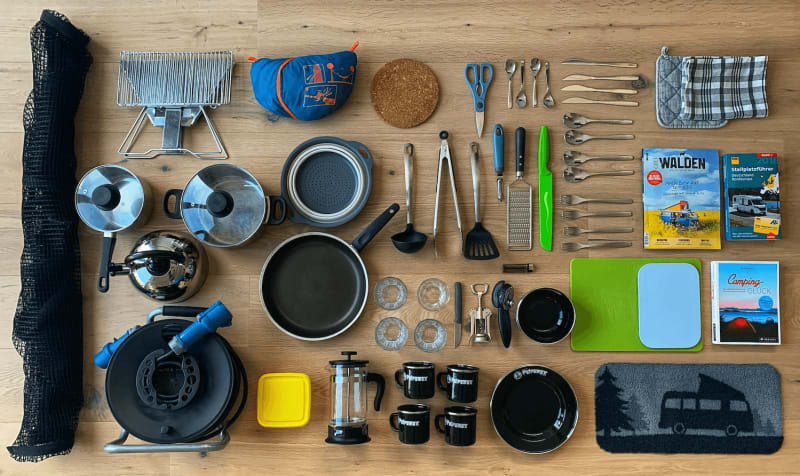 Image of cooking gear, cutlery, pans, pots and plates for campervan rentals in Iceland.
