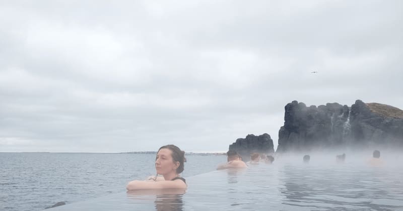 Image of a person relaxing in the sky lagoon in Iceland, a geothermal bathing spot in Reykjavik.