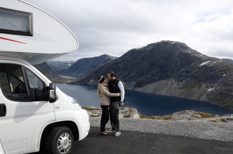 Image of two people in love standing beside a motorhome in Iceland