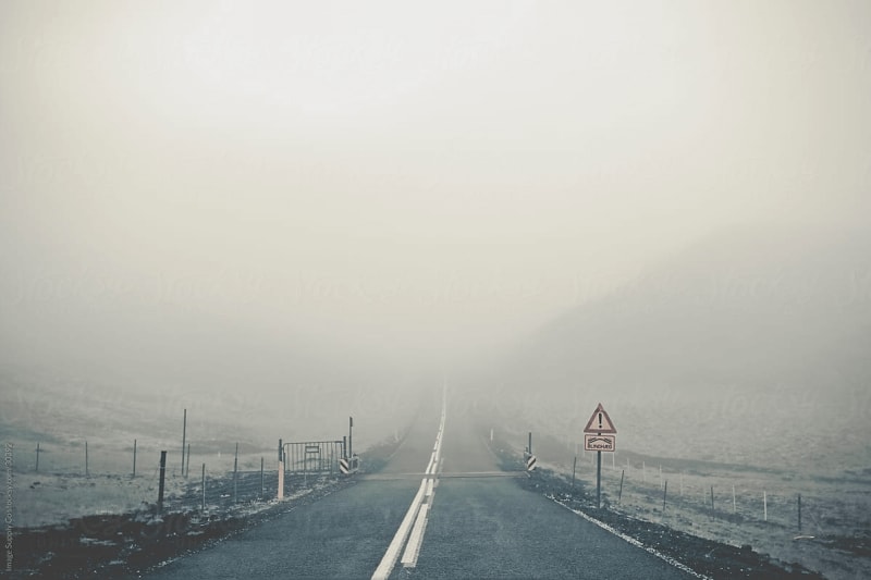 Image of a road covered in fog.