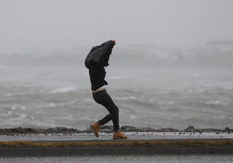 Image of a person standing in heavy winds in Iceland with this jacket up to catch the wind.