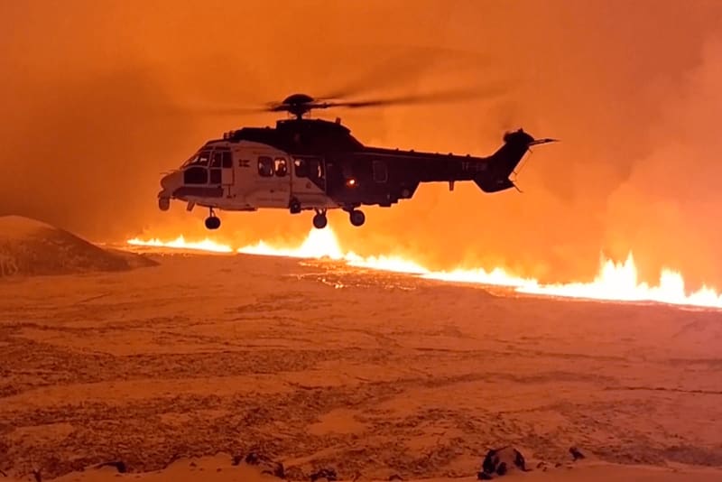 Image of a helicopter flying above the new volcano in Iceland 2023