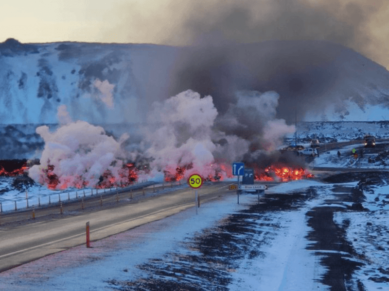 Image of the lava flow from the most recent volcanic eruption in Iceland. It is crossing Grindavikurvegur and raging towards hot water pipes for a large town.