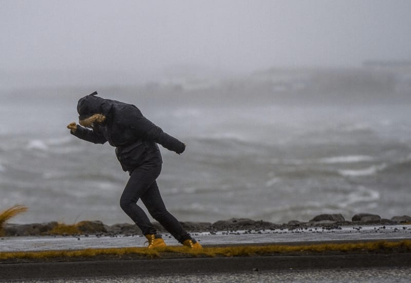 Image of a person in Iceland standing in a very windy weather