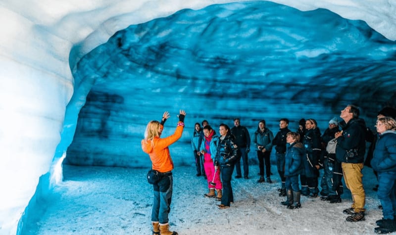 Image of a guided tour in an Ice Cave in Iceland, large group with family.