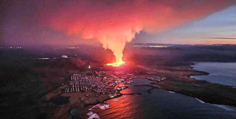 Image of the volcanic fissure outside of Grindavik and the town shown as well