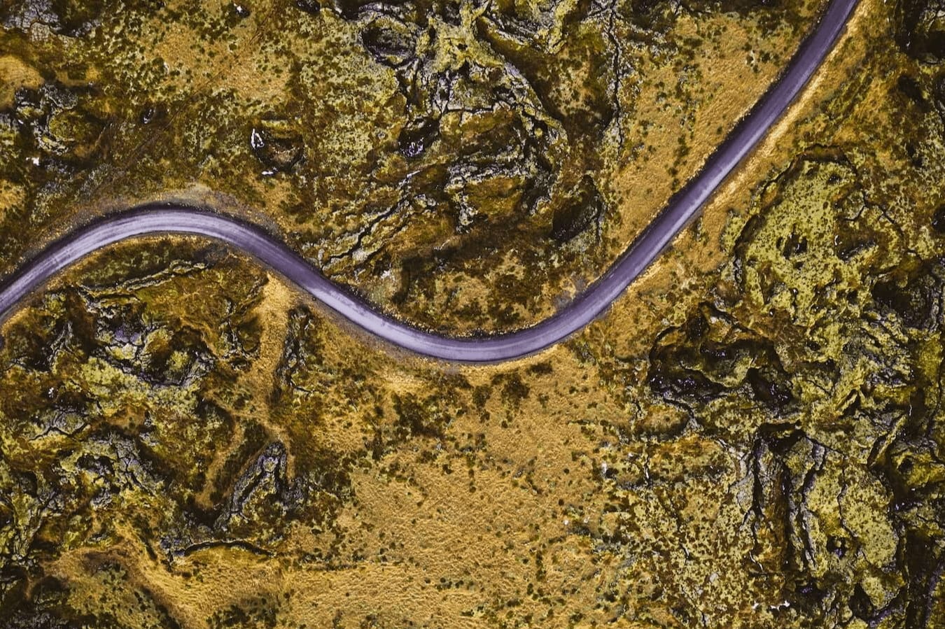 Aerial view of an F-Road in Iceland surrounded by moss.