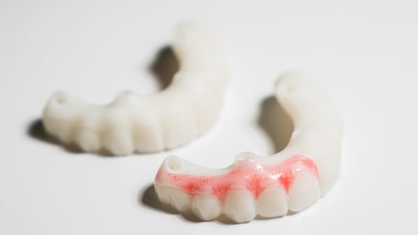 A pair of dentures made with OnX Tough 2