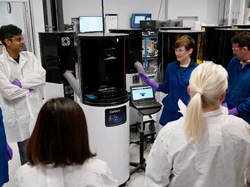 Two engineers talking in a printer lab