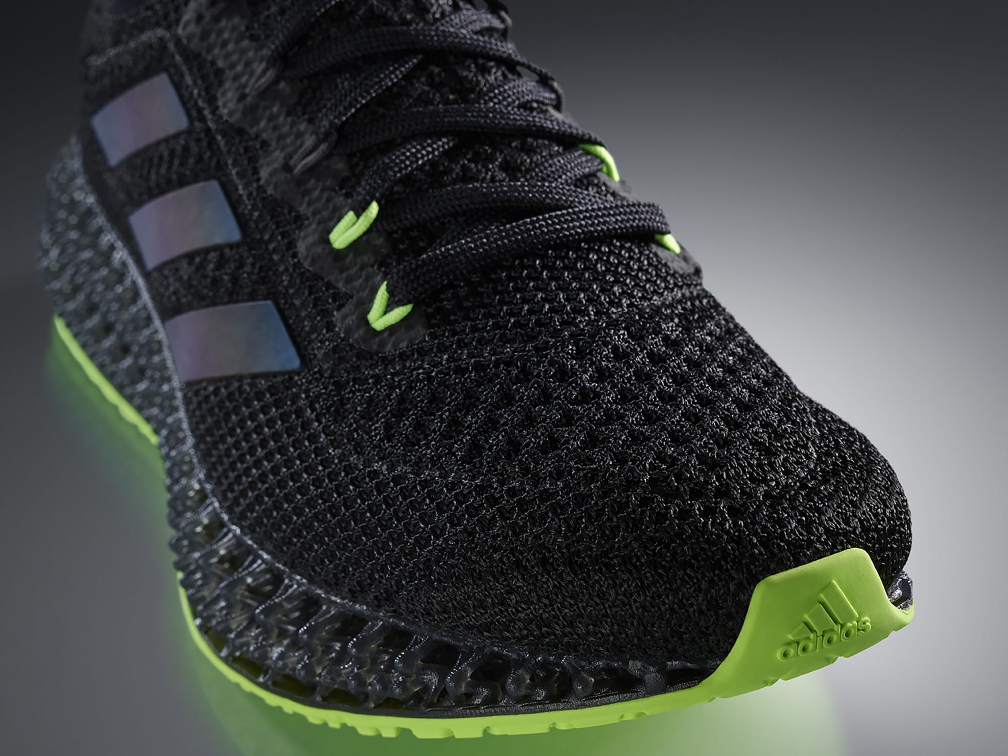 adidas 4DFWD sneaker, in black and neon green, close up on toe