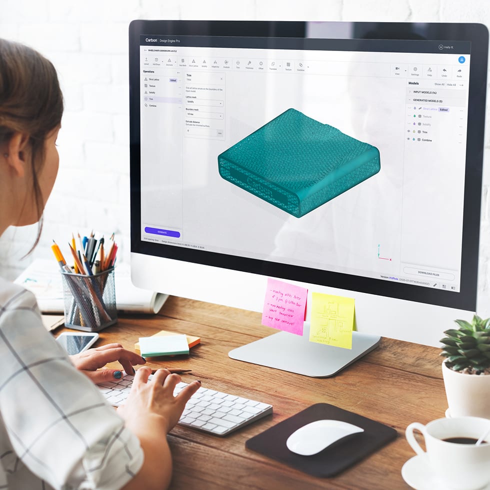 A woman using Carbon Design Engine software to model a wheelchair cushion