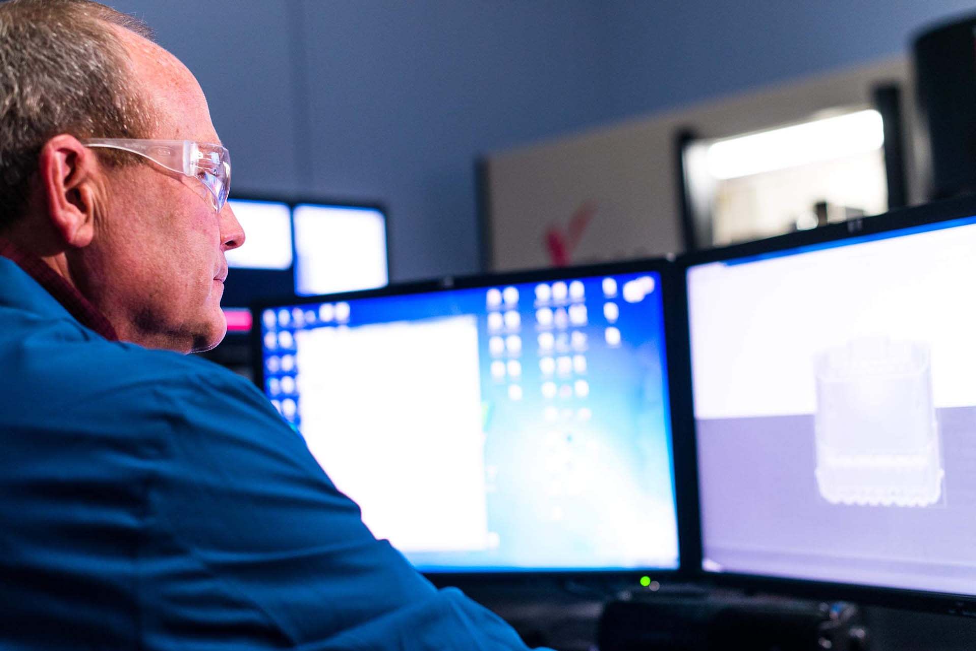 Jerry Reinhart looking at computer screens
