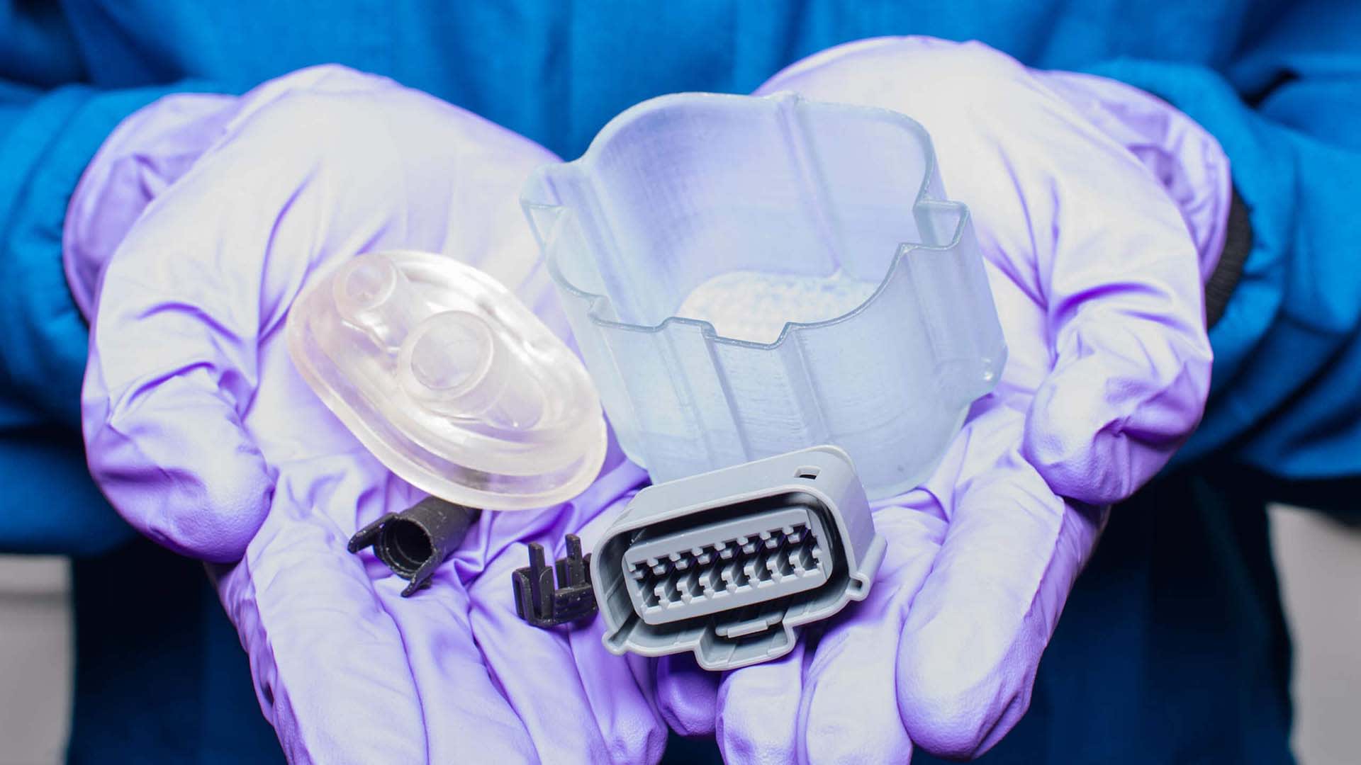 Technician holding printed parts