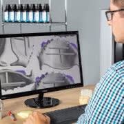 Man looking at scan designs on computer screen