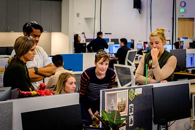 Carbon employees gathered around a monitor