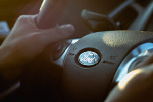 Holding a Ford steering wheel