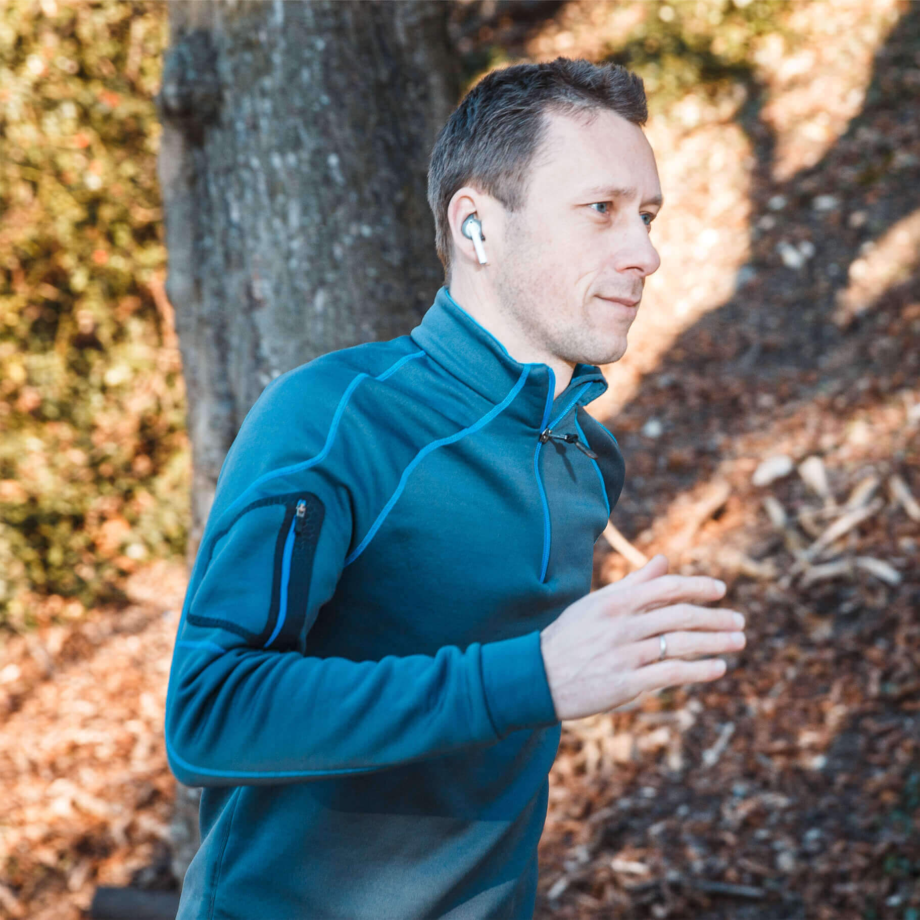 Man jogging with earbuds in ear