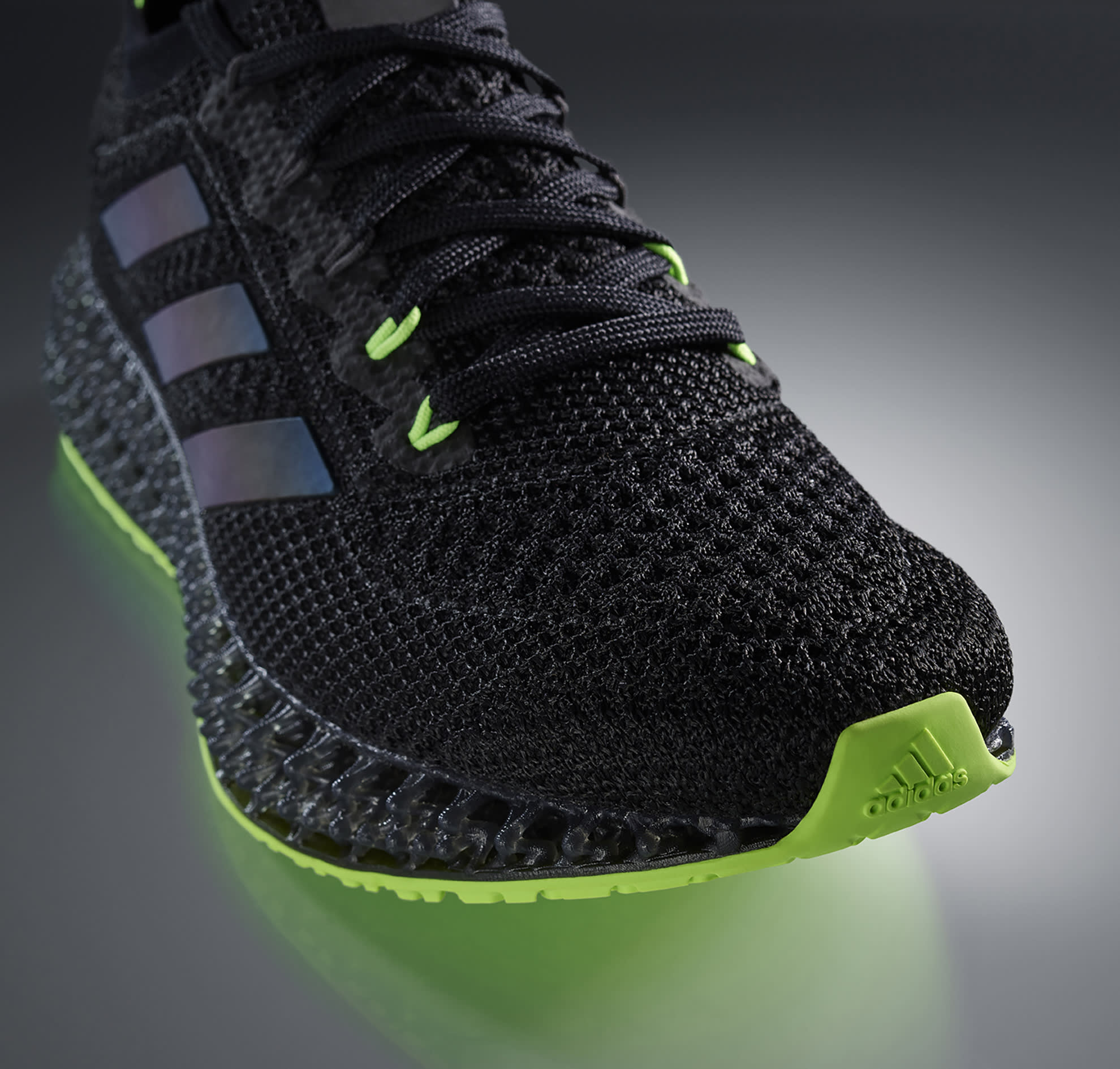 adidas 4DFWD sneaker, in black and neon green, close up on toe