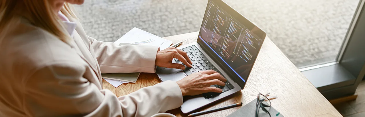 partial image of a female machine learning engineer working on her laptop