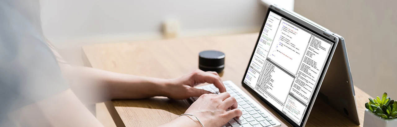 partial image of a software engineer working on her tablet reviewing codes