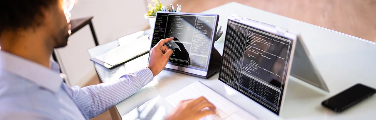 partial image of a male software engineer working on a project on his tablet