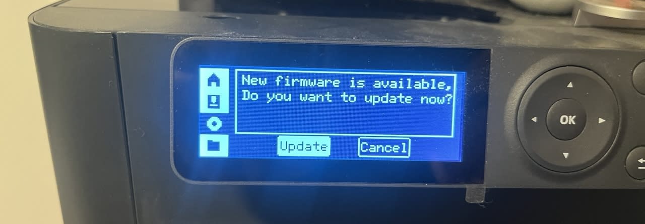 Photo of a small screen attached to a Bambulabs P1S that asks confirmation to update to the latest version of the firmware