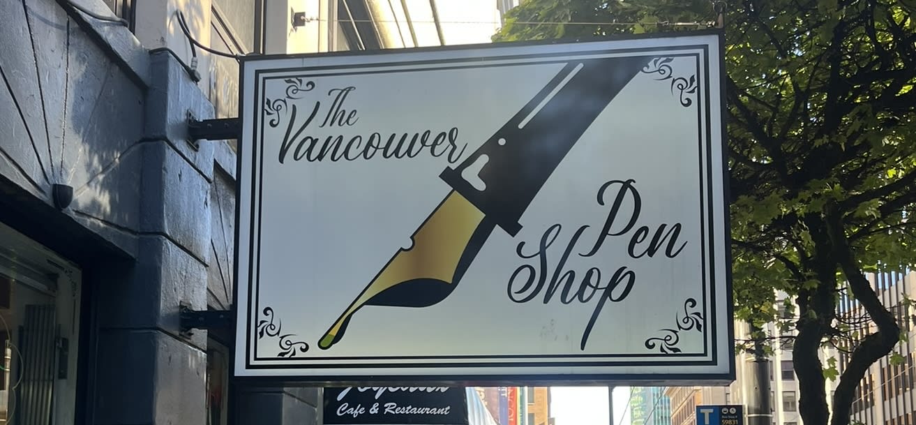 A photo of the sign for the Vancouver Pen Shop. It's just a fountain pen with the name of the shop in cursive