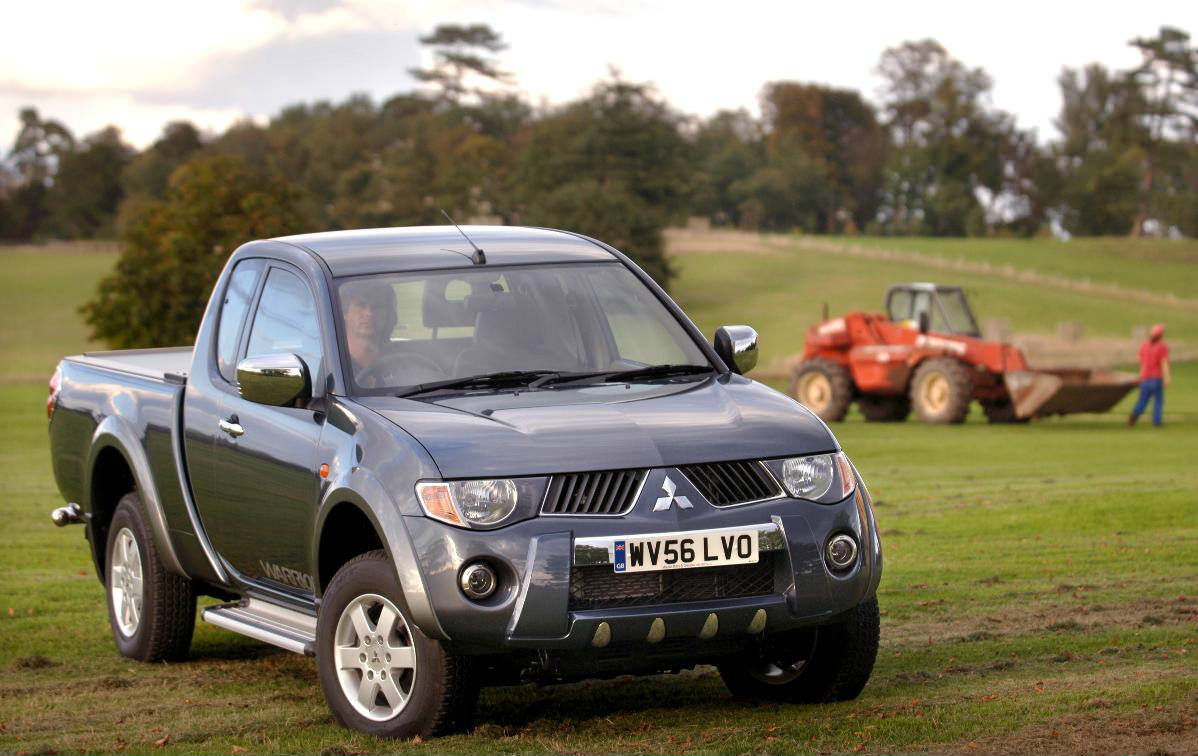 image of a blue mitsubishi l200 car in a field