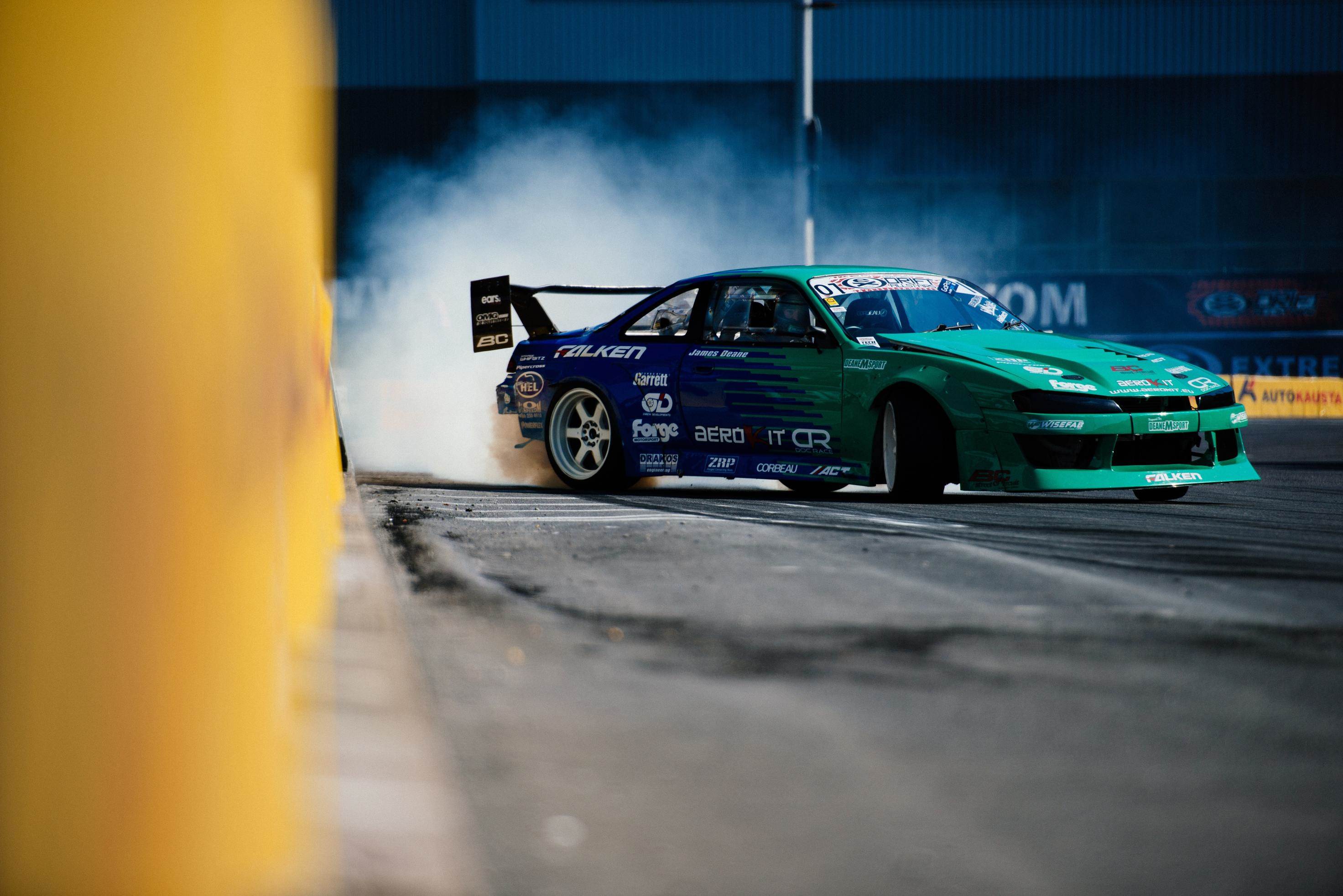 image of rear tyres smoking on a sport drifting car going round a corner