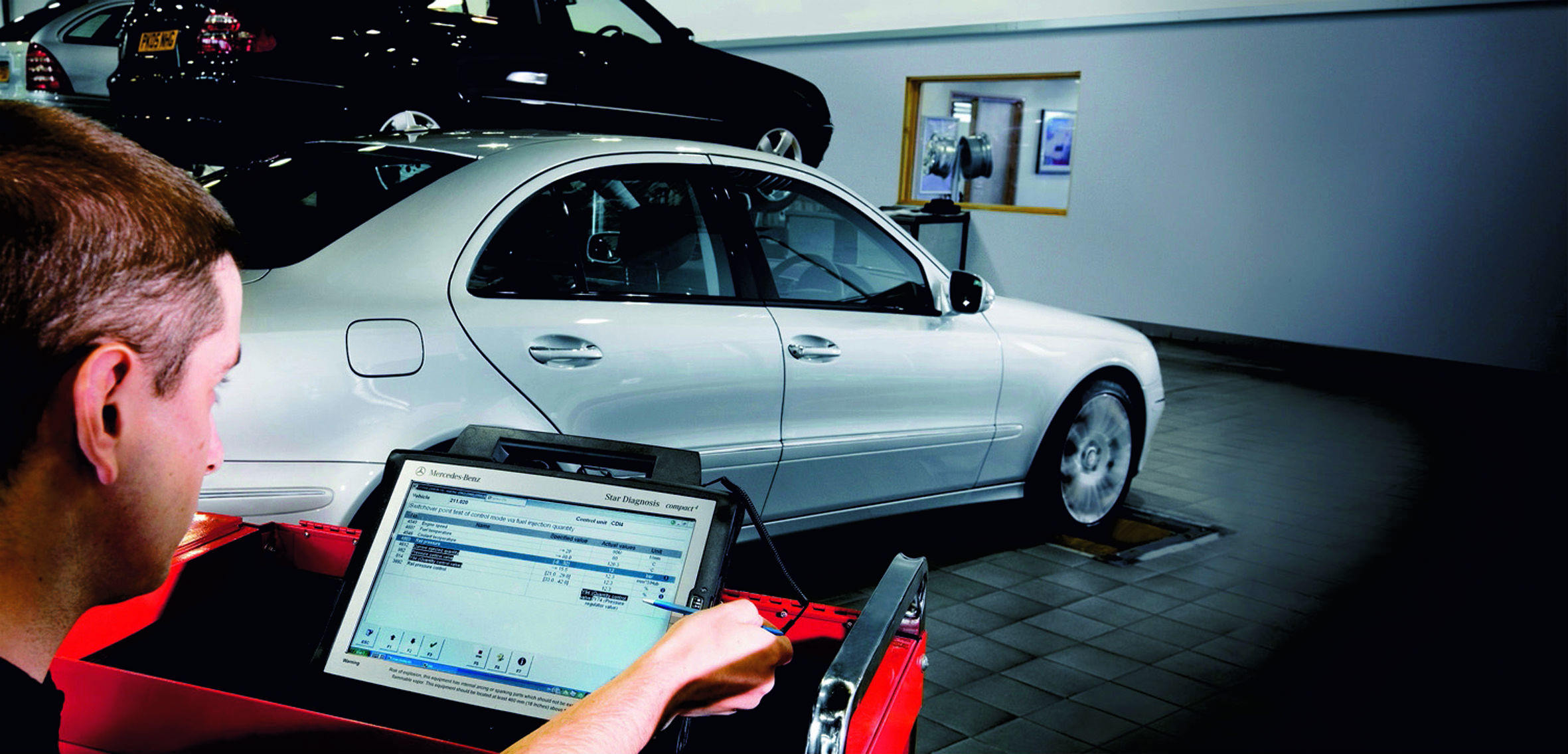 image of a silver mercedes-benz car being repaired