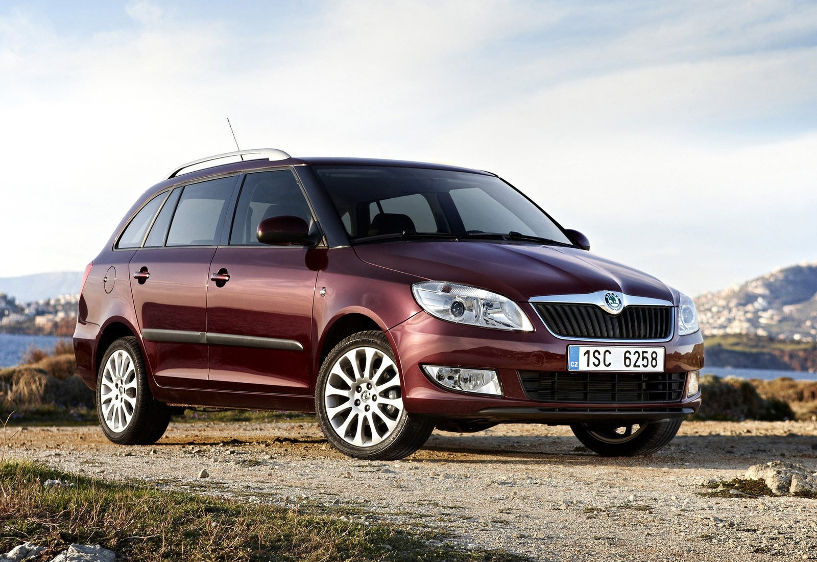 image of a maroon skoda fabia estate car exterior