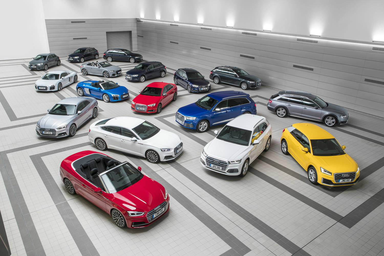 image of a variety of audi cars parked up in a showroom