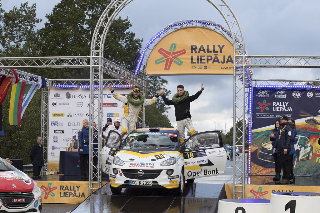 image of chris ingram celebrating on top of his rally car