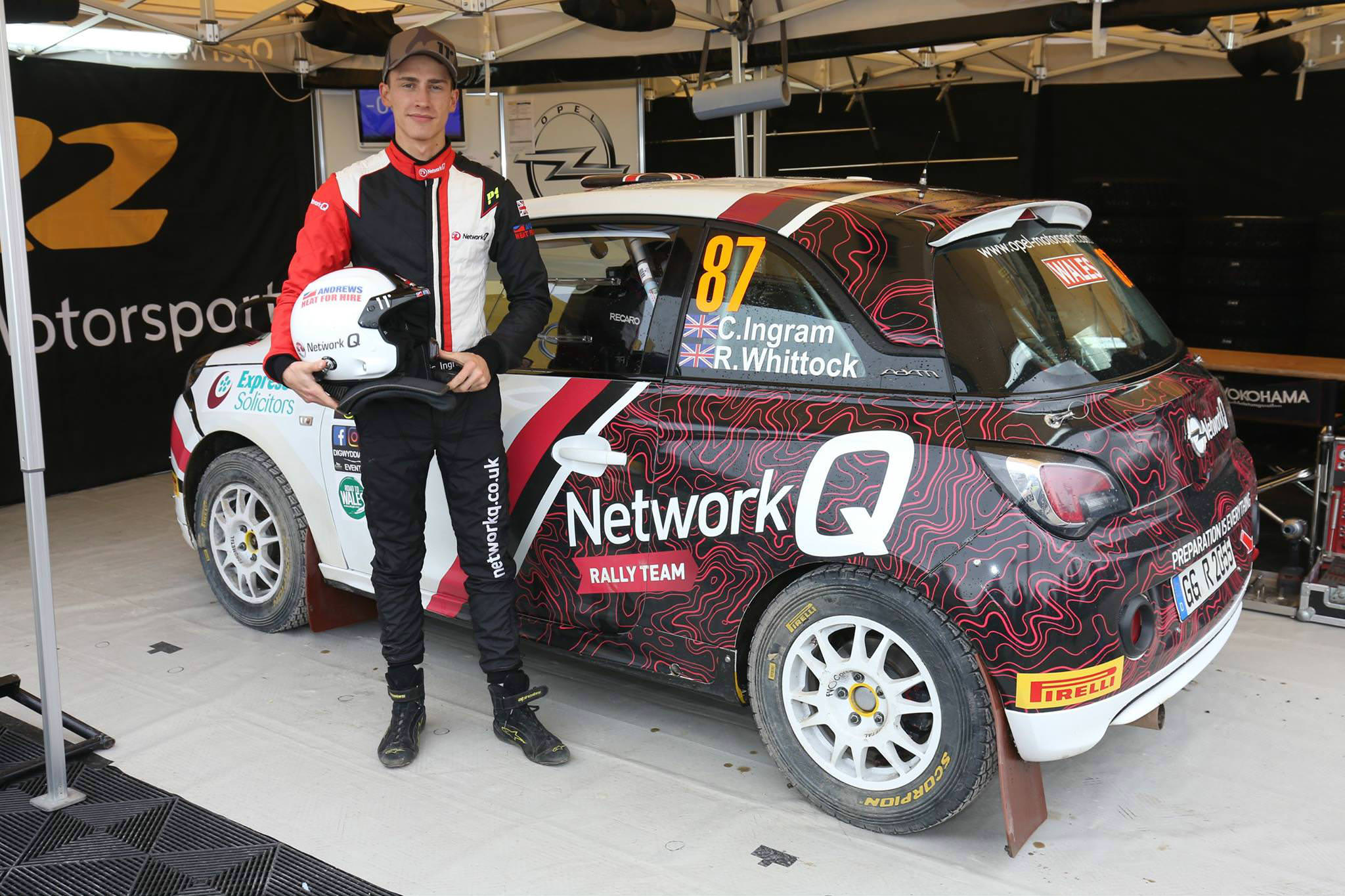 image of chris ingram rally driver standing next to his rally car