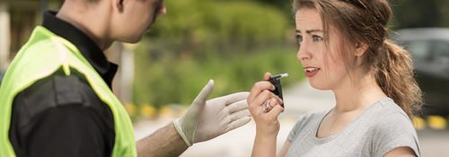 Image of woman using a Breathalyzer